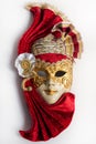 Traditional Venetian mask with red and gold decor isolated on white background. Royalty Free Stock Photo