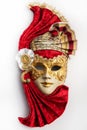 Traditional Venetian mask with red and gold decor isolated on white background. Royalty Free Stock Photo