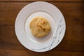 Traditional Venezuelan arepa, a golden-brown corncake, presented on a white plate