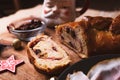 Traditional venezuelan food known as `pan de jamon` meaning ham with bread, slice with christmas decorations on wooden table, wi