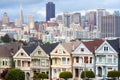 Traditional Victorian Houses known as Painted Ladies in Alamo Square and San Francisco city skyline