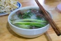 Traditional Vietnamese beef noodle soup with green onions, medium rare beefs, rice noodles eating with bean sprouts and lime. Pho Royalty Free Stock Photo