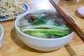 Traditional Vietnamese beef noodle soup with green onions, medium rare beefs, rice noodles eating with bean sprouts and lime. Pho Royalty Free Stock Photo