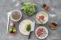 Traditional Vietnamese soup Pho bo with herbs, meat, rice noodles, broth. Pho bo in bowl with chopsticks, spoon. Space for text. T Royalty Free Stock Photo