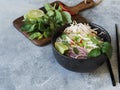 Traditional Vietnamese soup- pho ga in black bowl with chicken and rice noodles, mint and cilantro, green and red onion, chili, Royalty Free Stock Photo