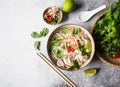 Traditional Vietnamese soup- pho ga in bowl with chicken and rice noodles, mint and cilantro, red onion, chili, bean sprouts and Royalty Free Stock Photo