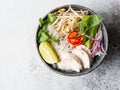 Traditional Vietnamese soup- pho ga in bowl with chicken and rice noodles, mint and cilantro, red onion, chili, bean sprouts and Royalty Free Stock Photo