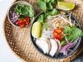 Traditional Vietnamese soup- pho ga in bowl with chicken and rice noodles, mint and cilantro, red onion, chili, bean sprouts and Royalty Free Stock Photo