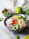 Traditional Vietnamese soup- pho ga in bowl with chicken and rice noodles, mint and cilantro, red onion, chili, bean sprouts and Royalty Free Stock Photo