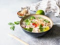 Traditional Vietnamese soup- pho ga in bowl with chicken and rice noodles, mint and cilantro, red onion, chili, bean sprouts and Royalty Free Stock Photo