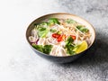 Traditional Vietnamese soup- pho ga in bowl with chicken and rice noodles, mint and cilantro, red onion, chili, bean sprouts and Royalty Free Stock Photo