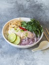 Traditional Vietnamese soup- pho ga in white bowl with chicken and rice noodles, mint and cilantro, green and red onion, chili, Royalty Free Stock Photo