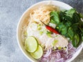 Traditional Vietnamese soup- pho ga in white bowl with chicken and rice noodles, mint and cilantro, green and red onion, chili, Royalty Free Stock Photo