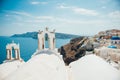 Traditional view of the sea and island with two white bell towers on Santorini Royalty Free Stock Photo