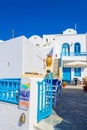Beautiful traditional white villa with blue details and cozy patio Santorini Greece