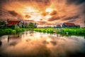 Traditional village with dutch windmills and river at sunset, Holland, Netherlands. Royalty Free Stock Photo