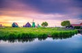 Traditional village with dutch windmills and river at sunset, Holland, Netherlands. Royalty Free Stock Photo