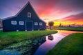 Traditional village with dutch windmills and river at sunset, Holland, Netherlands. Royalty Free Stock Photo