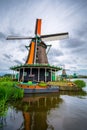 Traditional village with dutch windmills and river at sunset, Holland, Netherlands. Royalty Free Stock Photo