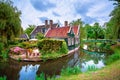 Traditional village with dutch windmills and river at sunset, Holland, Netherlands. Royalty Free Stock Photo