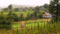 Traditional village houses in mountain village. Typical rural scene. Summer in the village. Green fields and forests in