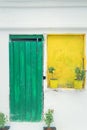 Vintage style old greek house with green door and yellow window in Sithonia, Chalkidiki. Royalty Free Stock Photo