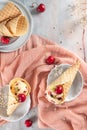 Traditional waffle cones with ice cream and cherry fruits on marble stone surface Royalty Free Stock Photo