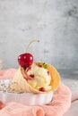 Traditional waffle cones with ice cream and cherry fruits on marble stone surface Royalty Free Stock Photo