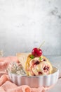 Traditional waffle cones with ice cream and cherry fruits on marble stone surface Royalty Free Stock Photo