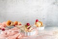 Traditional waffle cones with ice cream and cherry fruits on marble stone surface Royalty Free Stock Photo