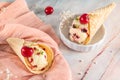 Traditional waffle cones with ice cream and cherry fruits on marble stone surface Royalty Free Stock Photo