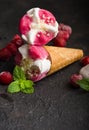 Traditional waffle cones for ice cream oncocncrete table. Cherry ice cream and fresh cherries. Cones filled with ice cream Royalty Free Stock Photo