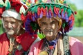 Traditional water sellers with typical colorful hats walking through streets as attraction for tourists in Marrakesh, Morroco Royalty Free Stock Photo