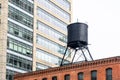 Traditional water tank on the roof of an old brick building Royalty Free Stock Photo
