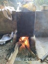 White smoke coming out from the pan. Cooking Rajasthani food on mud challah or stove or oven