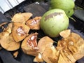 traditional way of peeling coconut
