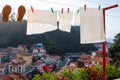 Traditional way to wash and dry clothes in Spain. White clothes hanging outdoors. Beautiful town, colorful houses built on the Royalty Free Stock Photo