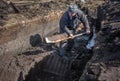 An Irish turf cutter, cutting sods of turf with a sleÃÂ¡n.