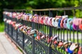 Traditional wedding locks on the fence of the bridge