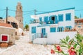 Traditional white greek house with blue shutters in small village at island Halki, Greece Royalty Free Stock Photo