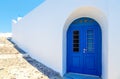 Traditional white Greek house facade with blue door Santorini, Greece Royalty Free Stock Photo