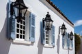 traditional white house with black shutters and lanterns against the blue sky Royalty Free Stock Photo
