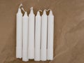 Traditional white household wax candles for power cuts etc. With brown paper packaging