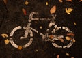 A traditional white road sign, bicycle symbol, on the dark cement. This symbol sign is specified that this lane of the road is for Royalty Free Stock Photo