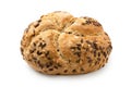 Traditional whole wheat kaiser roll with linseeds and sesame seeds isolated on white