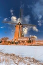 Traditional windmills and frozen canal, blue sky, Kinderdijk, Netherlands Royalty Free Stock Photo