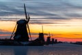 Traditional windmills on ice Kinderdijk, Netherlands at sunset Royalty Free Stock Photo