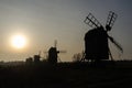 Traditional windmills silhouettes by the setting sun