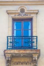 Pastel brick and wooden traditional window and balcony in Spain with stucco decoration Royalty Free Stock Photo