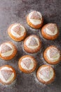 Traditional winter sweet Semla semlor or fastlagsbulle flavored with cardamom, filled with almond paste and whipped cream closeup